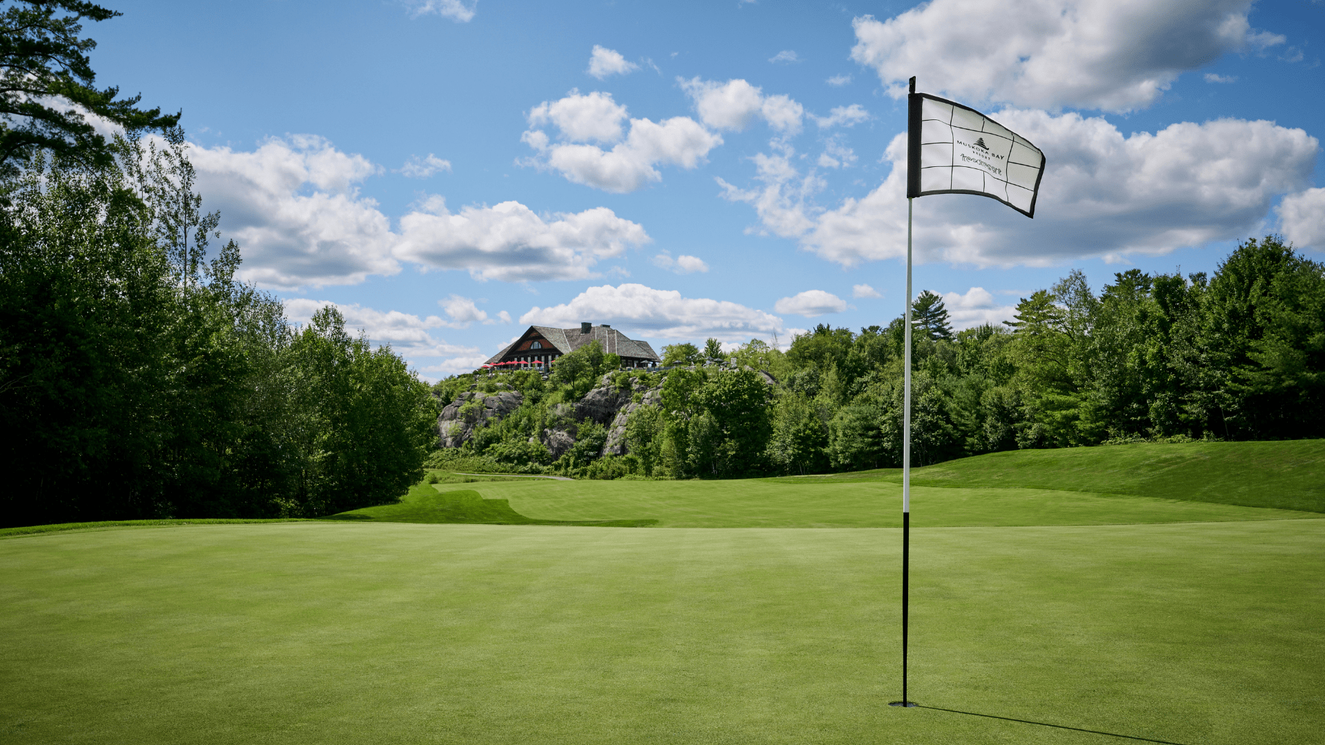 A white flag on a golf hole at Muskoka Bay Resort